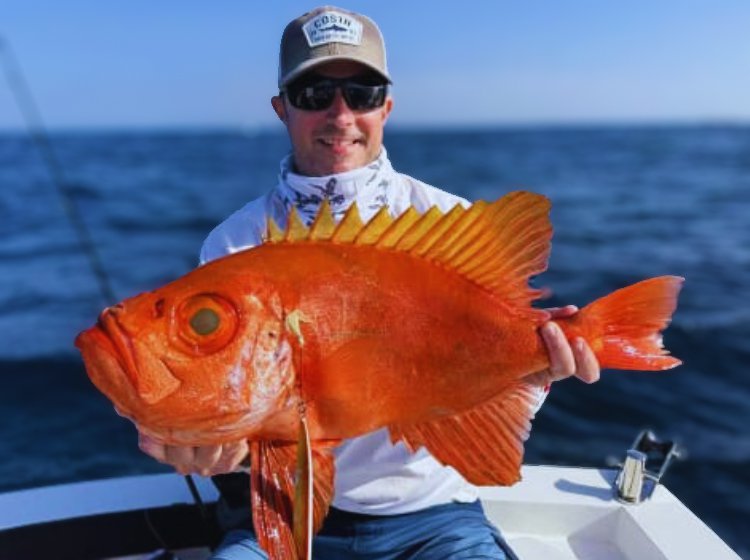 Mark Brewitt with a strange Red Bigeye caught at a depth of 100m