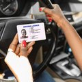 Lady holding her driving licence
