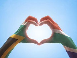 SA flag colours painted on hands making heart
