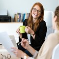 Women drinking coffee in the office iStock