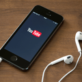 Apple iPhone 5S with YouTube logo on the screen