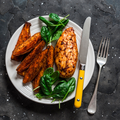 A baked chicken breast with sweet potato and spinach