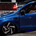 A blue supped up Volkswagen vehicle parked at a petrol station