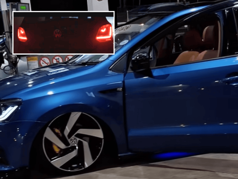 A blue supped up Volkswagen vehicle parked at a petrol station