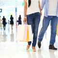 A couple holding hands while shopping at mall