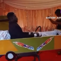 A dead man sits upright inside a taxi coffin