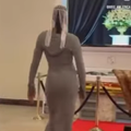 A female model walks the red carpet at a funeral