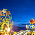 A ferris wheel and gravity machine at amusement park fun fair