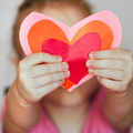 A girl holds up a DIY Valentines Day card