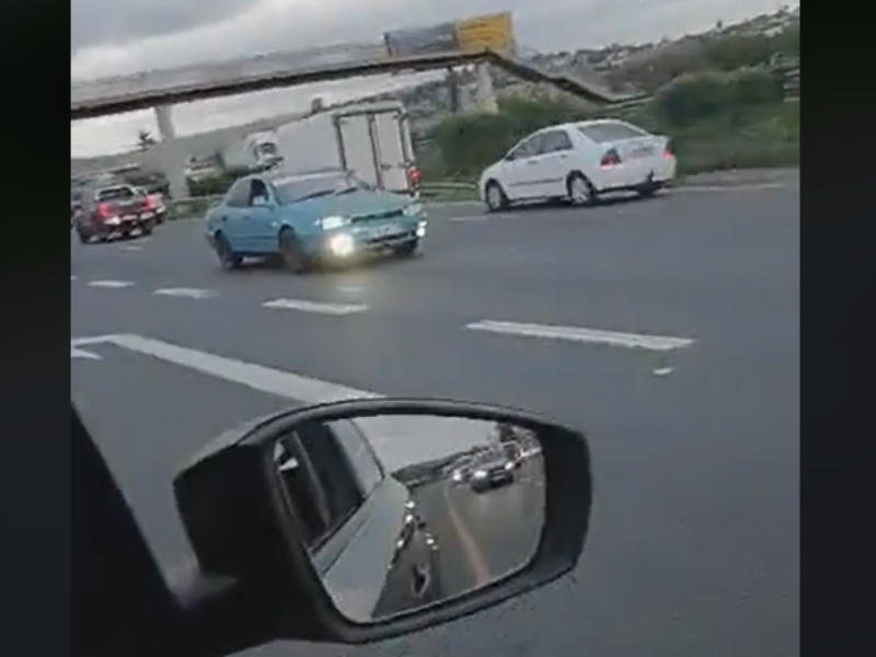 A green car drives in reverse on the N2 near Umgeni Road in Durban