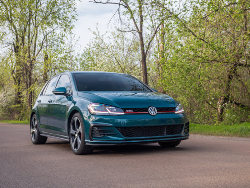 A green Volkswagen Golf GTI on the street