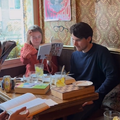 A group of people reading at a coffee shop in Amsterdam