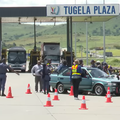 A group of police officials at a roadblock near a toll plaza