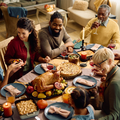 A happy multigeneration family gathering for a meal at Christmas