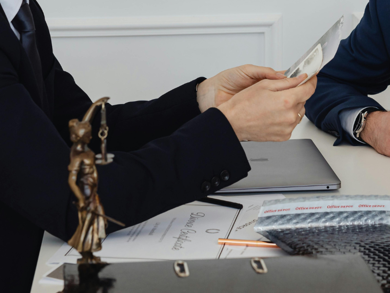 A lawyer looking over something with a couple who are getting divorced