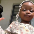 A little girl posing with mop strands on her hair