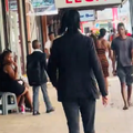 A man dressed like movie character John Wick walking in PMB