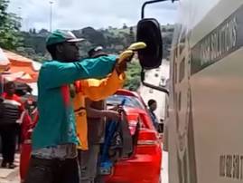 A man holding a banana as if it is a gun to hold up CIT guards