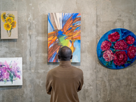 A man looking at art in a gallery