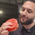 A man looking at his watermelon sandwich