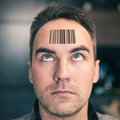 A man looks up at his QR code tattoo on his forehead