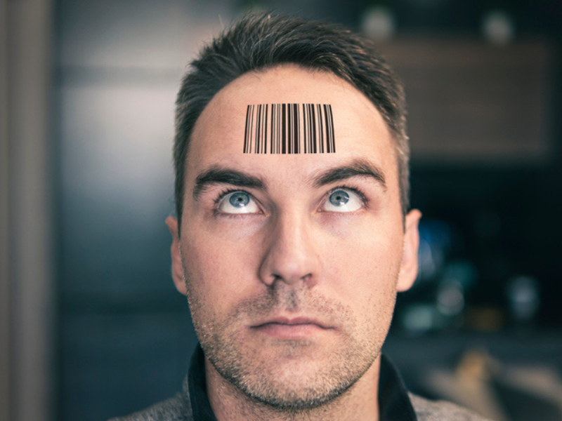A man looks up at his QR code tattoo on his forehead