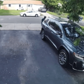 A man walks to his vehicle parked in the driveway