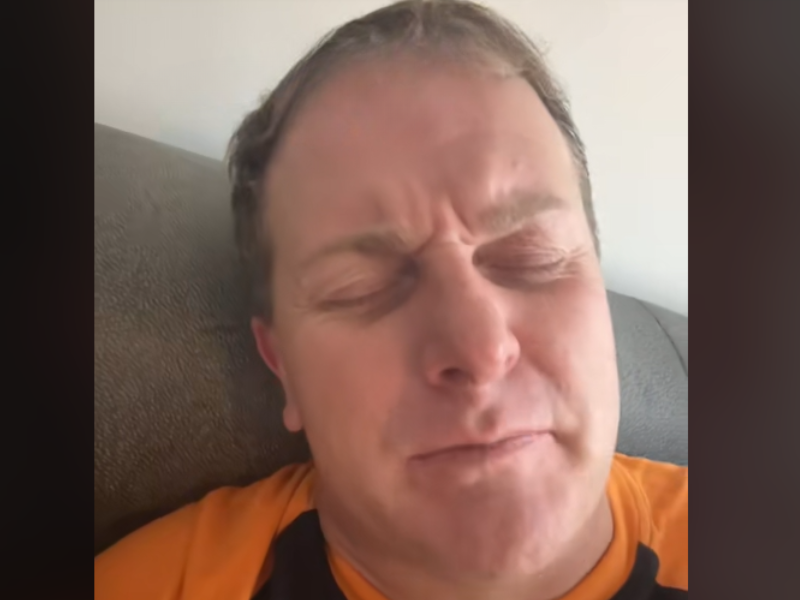 A man with his eyes closed praying