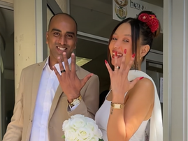 A married couple show off their rings in front of the Home Affairs office in Cape Town