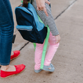 A mother and daughter walking to school entrance together