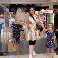 A mother walking out of a shop in Gateway with her two daughters