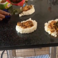 A person dishing out food on the granite kitchen counter tops