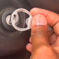 A person using a bottle opener to start their car