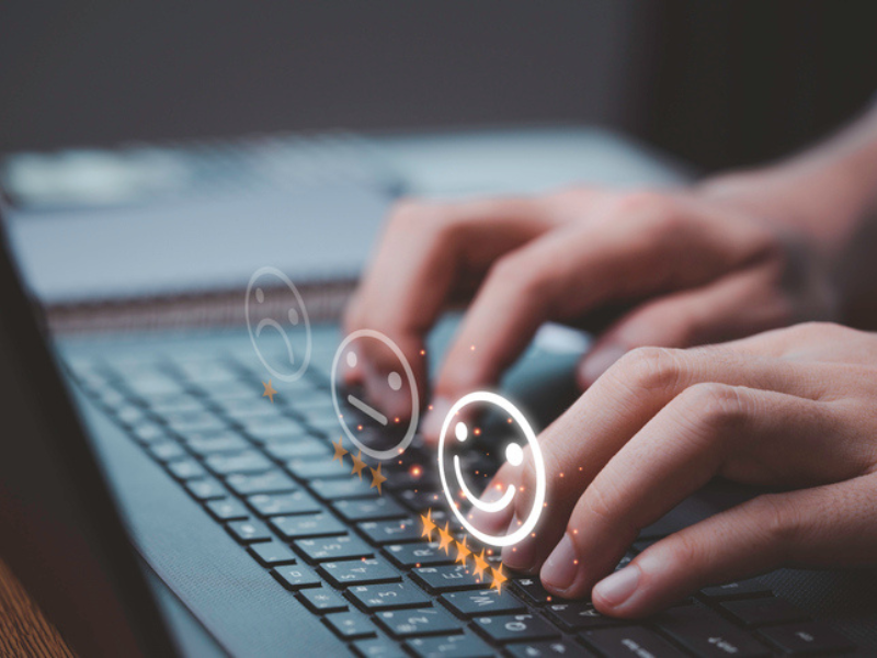 A person's hands typing on a laptop