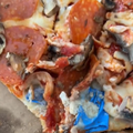 A pizza with rubber glove baked into the base