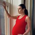 Pregnant Lea Michele wearing a red dress