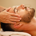 A relaxed man during a head massage at spa