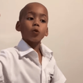 A school boy uses his hands while speaking