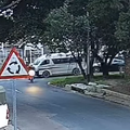 A taxi gets hit by an Aston Martin at a traffic circle