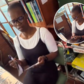 A teacher looking at a picture of herself from her younger days