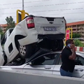 A white van on top of another vehicle at a toll gate in South Africa