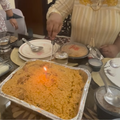A woman celebrates with biryani as her birthday cake