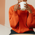A woman drinking a cup of coffee