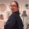A woman showing off how her jacket is upside down