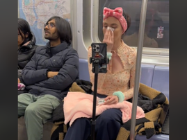 A woman videoing herself while doing her skincare routine