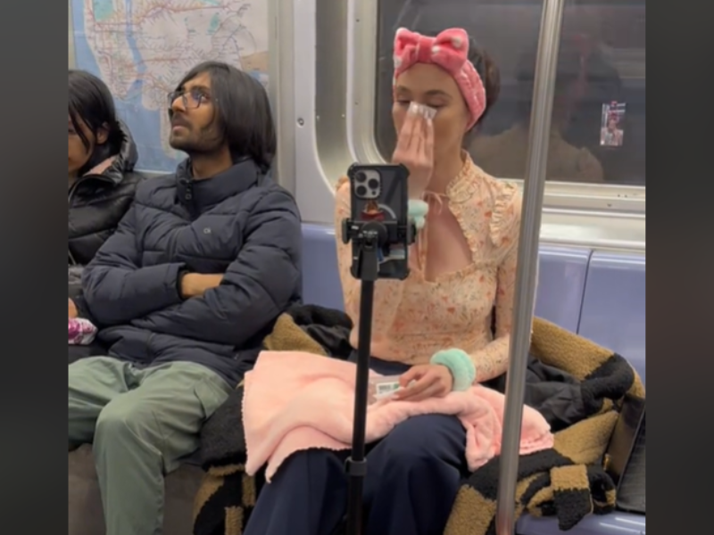 A woman videoing herself while doing her skincare routine