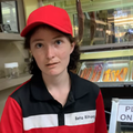 A woman wearing a uniform serving biltong looks shocked