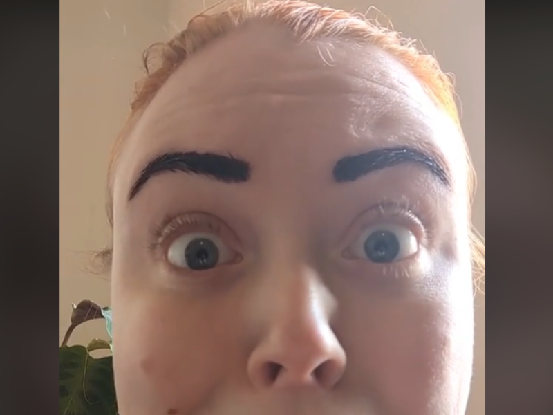 A woman with a shocked look on her face and tinted eyebrows