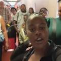 A young African woman standing in a queue to board a flight