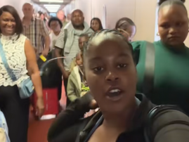 A young African woman standing in a queue to board a flight